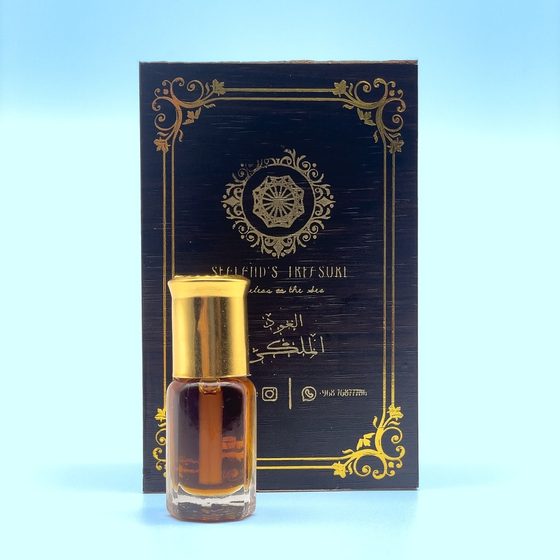 Sealand's Treasure oud oil in a gold-capped bottle beside its navy presentation carton